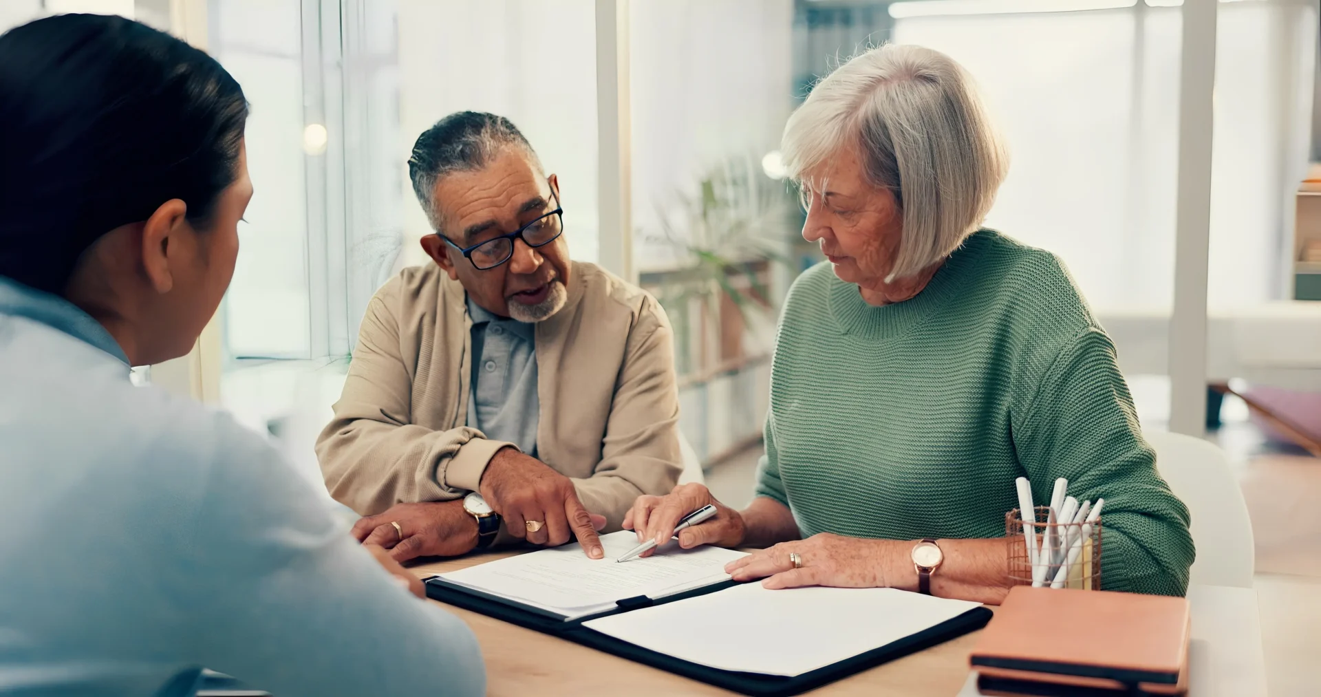 Senior couple reviewing documents together at home.
