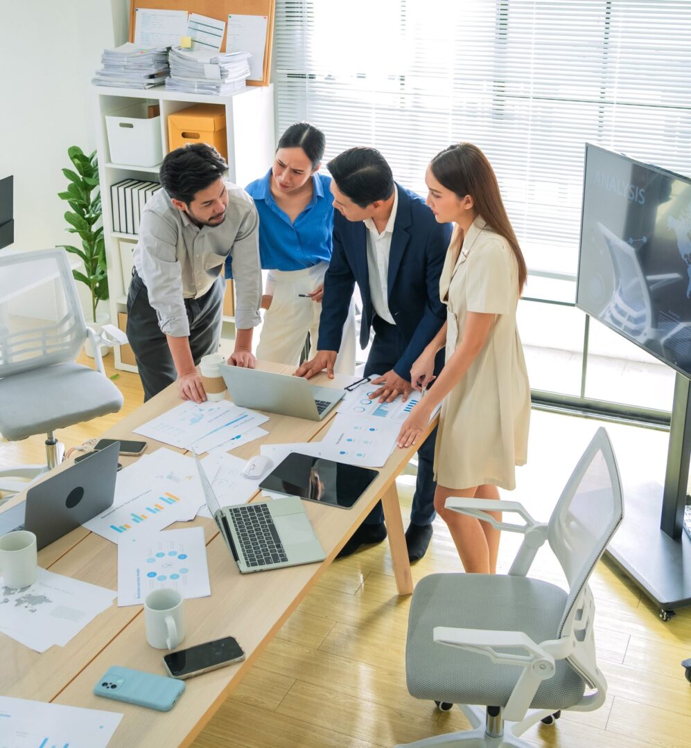 Group reviewing charts on laptop